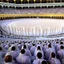 Placeholder: The scene in Mecca: People wearing white Ihram clothes, men without head coverings, women with veils, circumambulating around the Kaaba, and above them are transparent white spirits of children, men, and women with wings revolving around the Kaaba.