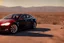 Placeholder: A Tesla 'Model S' is parked, in the Mojave Desert. (CINEMATIC, WIDE ANGLE LENS, PHOTO REAL)