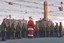 Placeholder: Santa Claus is visiting a factory and give all the workers presents, cartoon style Simon Stålenhag