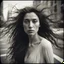 Placeholder: a woman with long wild hair on a windy day, in the style of toy camera effects, haunting elegance, frozen movement, captivating gaze, voigtlander bessa r2m, black paintings, new york school --ar 71:128 --stylize 750 --v 6