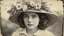 Placeholder: Vintage photograph of a young woman in a hat with flowers, torn edges, cracks