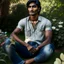 Placeholder: an 24 year old indian man, oval face, tanned skin, wearing shirt and jeans, sitting in a garden, peaceful