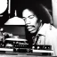 Placeholder: Jimi Hendrix at a turntable with headphones on being a DJ, cigarette