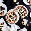 Placeholder: pizza with white chocolate, black chocolate, napkins, black table