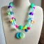 Placeholder: Chunky clear polyester necklace with colorful beads and charms