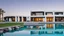 Placeholder: Description of a modern Emirati style villa: Located on a magnificent piece of land in the heart of the Emirates, our villa embodies the finesse of design and detailing that promises a luxurious residential experience. This two-story villa, with its elegant and contemporary spaces, stands out. The exterior walls of the villa are made of black and white stones, adding an elegant and luxurious touch to the design. This combination of black and white stones creates a beautiful contrast, highlight