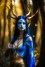 Placeholder: A picture of a beautiful blue faced indian goddess with skin painted blue, blue painted body, blue painted torso, wild black hair, stag antlers, elven ears, golden skirt, holding a staff in a sunny forrest