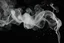 Placeholder: White smoke spiraling away in smaller strands from bottom right. small streams of electricity throughout. black background