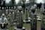 Placeholder: A black graveyard with ghosts designed in African masks painted by Jean Dubuffet