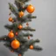 Placeholder: an orange branch of a Christmas tree on a gray background with sulfur Christmas toys