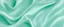 Placeholder: Light pale blue green abstract background with space for design. Mint color. Silk fabric surface.