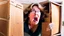 Placeholder: woman starts frantically tearing apart large door sized box scaring her husband