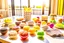 Placeholder: amigurumi desserts, cookies and macarons on lace tablecloth in a modern kitchen in sunshine