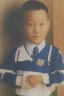 Placeholder: 6 year old asian schoolboy in his school uniform portrait, high details