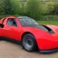 Placeholder: Tesla roadster blended with a reliant robin