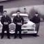 Placeholder: a 50s Greaser BAND standing in front of a hot rod