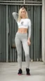 Placeholder: photography of skinny blond girl, face frontal, body frontal, satin yoga pants, standing, leohex, fashion photography, bright daylight, surfer hair, concrete background, ghetto gym, raw, grit, open mouth,