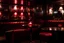 Placeholder: cocktails in dark smoky lounge with red light and retro vibe