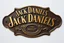 Placeholder: a Jack Daniels style graphic element made of brass