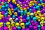 Placeholder: a field of 1000s of cartoonish, anatomically correct, skulls, vivid RANDOM BRIGHT neon colors, dark comedy, well lit, high detail, photorealistic, horrorcore, fun, scary, none featured, each a different color or hue,