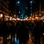 Placeholder: dark city at night, lots of people, blurred, focus on one person in the middle