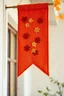 Placeholder: an autumn colored cloth banner hanging with embroidered leaves and slightly pointed bottom