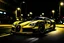 Placeholder: supercar buggati with black and yellow shiny paint at night in a road front sine park car front tyre are bend in right lights of