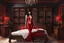 Placeholder: photorealistic slim woman looking like Vampirella in a bedroom with wooden furniture, bookcases and opulence