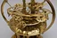 Placeholder: Art Nouveau steampunk orrery, with clockfaces, cogs, springs, polished brass