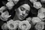 Placeholder: (best quality)1, (best detail)+, (best resolution)1, (realistic)1, closeup of a woman's face, eyes closed, tears, deep shadows, (film grain)1.2, skin glow, (a ring of bright roses around her head)1.2, a bouquet of flowers in her hand, deep emotion, in a cemetery, destaturated color, (her hair seems like a glowing halo)1.2