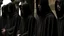 Placeholder: hooded monks in black robes in egypt