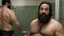 Placeholder: two ugly muscular chubby arab 40 years old similar to bud spencer, very detailed, full figure shot, very realistic photography, dim light, view from below, tiled restroom, tattoo, masculine bearded, white substance dripping from beard, with glue stuck to and dripping from beard,, , mature barely burly bearded muscled and robust