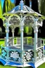 Placeholder: magic carved gazebo, garden, flowers, butterflies, colors: snow-white, silver, milky, mint, glaze, pearl, turquoise, cream, mother-of-pearl, dawn: sfumato, complex abstraction in the style of Dali