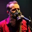 Placeholder: en skäggig man som försöker sjunga med en gasmask på en scen, gasmasker, dom kallar honom för babyface för att ser så barnslig ut