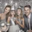 Placeholder: Photograph of a happy couple with kids celebrating with silver party decoration.