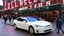 Placeholder: A Tesla's 'Model S Plaid' is parked, at the 'Pike Place Market', in Seattle. CINEMATIC. WIDE ANGLE LENS. PHOTO REAL.