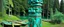 Placeholder: A turquoise secret island with a cove designed in pacific Northwest totem poles painted by Jeffrey Kolker