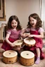 Placeholder: Scarlett and Violet playing the bongos together