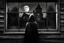 Placeholder: fantasy, black and white, surrealist, high contrast, high shadows, ambient mystery, tim burton character, a woman with cape and hood is outdoor, a woman old wood house and look through window inside house, woman with her back to the camera, close up window, light on inside house, woman in front of window, light on inside house, reflection moon in a glass window