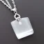 Placeholder: Clear polyester necklace with a chunky silver pendant in the shape of a key