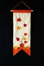 Placeholder: an autumn colored cloth banner hanging with embroidered leaves and slightly pointed bottom, on dark background