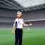 Placeholder: Hillary Clinton in a referee jersey officiating for a soccer match at Wembley Stadium