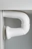 Placeholder: A studio-shot photograph of a high-quality white sewage plumbing PVC 90-degree elbow. The image is captured using professional photography techniques, ensuring every detail is crisp and clear. The depth of field technique is utilized to focus on the intricate structure of the elbow, while the background is elegantly blurred, giving it a luxurious and sophisticated look. The matte finish adds a touch of elegance, and the clear water flowing through the elbow creates a sense of movement and dynami