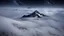 Placeholder: looking down from space at a misty mountain coming through the mist and surrounded by the mist at night starry sky