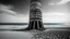 Placeholder: A black and white photograph captures a surreal scene on a beach, dominated by a tall, cylindrical structure reminiscent of a tower, leaning at a precarious angle. The tower is made of a rough, textured material, possibly concrete or stone, and is punctuated by numerous rectangular openings that resemble windows. The beach is sandy, with visible windswept patterns, and the ocean stretches to the horizon, churned by waves. The sky is filled with dramatic, swirling clouds, which contribute to the