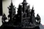 Placeholder: A black clockwork castle with a stronghold designed in Javanese shadow puppets
