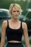 Placeholder: full color Portrait of 18-year-old prude Charlize Therone, with short, pixie-cut blonde hair, tapered on the sides, wearing a black cotton sports bra and short - well-lit, UHD, 1080p, professional quality, 35mm photograph by Scott Kendall