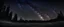 Placeholder: Blue dark night sky with many stars above field of trees. Yellowstone park. Milkyway cosmos background