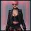 Placeholder: full body portrait -- an absolutely stacked female strawberry with pixie-cut hair, a perfect hourglass figure, perfect face, wearing a studded, black leather biker's jacket and pants with 12-inch platform boots and goggles,