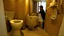 Placeholder: Hotel room toilet overflows while man tries to still defecate into it